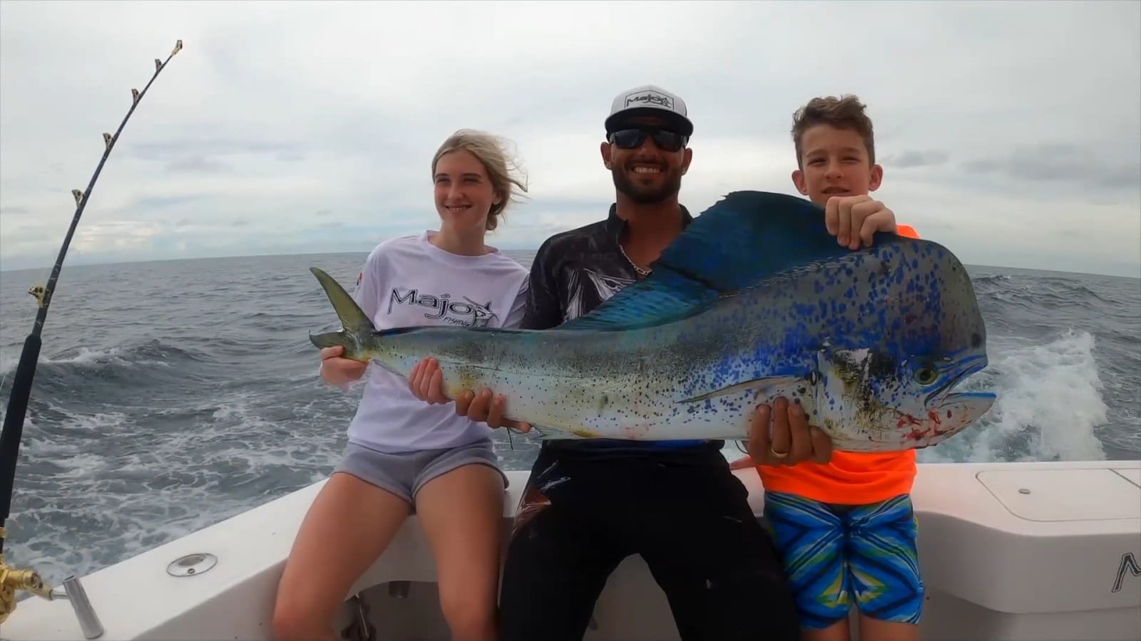 Family holding a trophy dorado catch off Panama