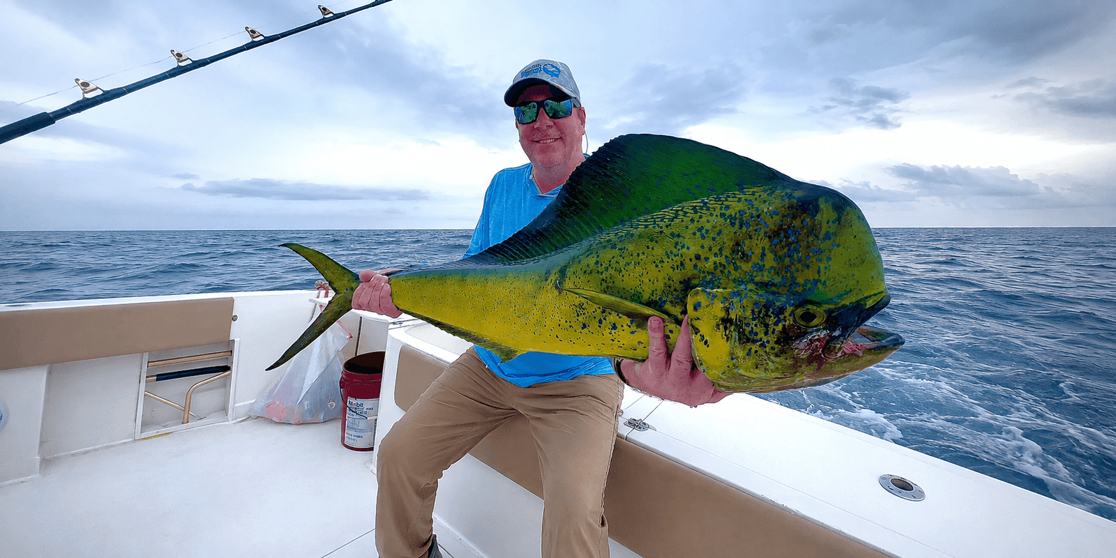 Angler holding a big dorado (mahi-mahi) caught off Panama's Pacific coast